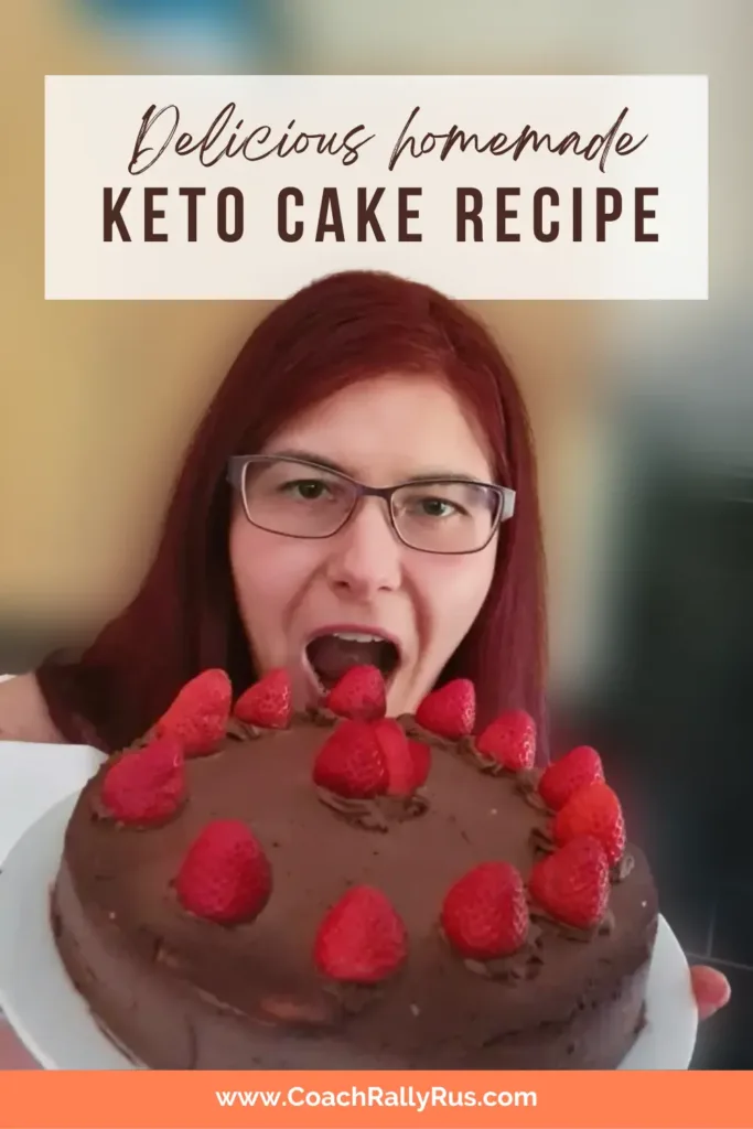 A Pinterest pin featuring a delicious homemade keto chocolate cake topped with strawberries and cream, presented by a person whose face is not visible. The text on the image promotes the keto cake recipe available at www.CoachRallyRus.com.