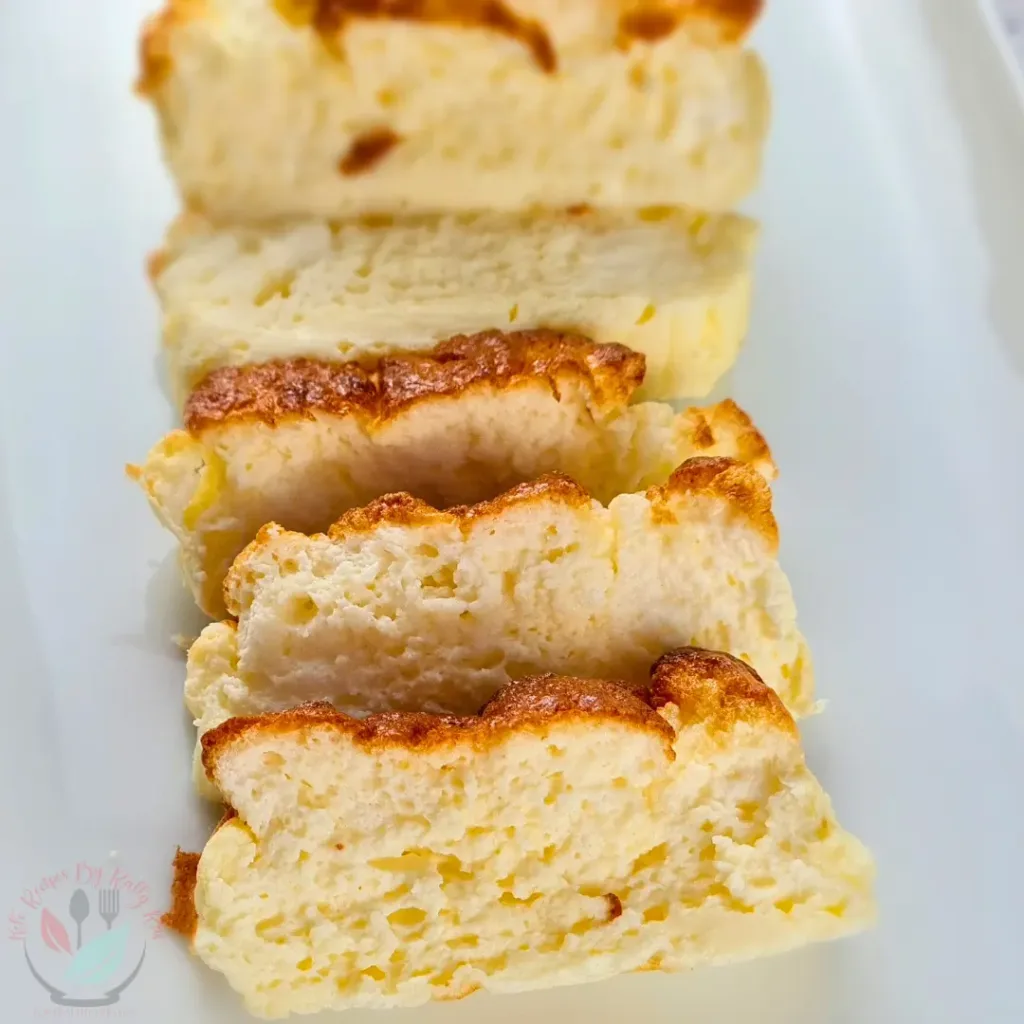 Three slices of golden brown 2 Ingredient Cottage Cheese Bread stacked on a white surface, showcasing their fluffy texture and crispy edges.