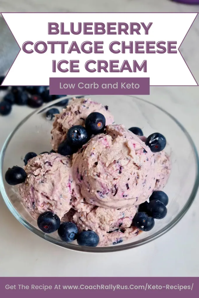 Pinterest pin of Easy High Protein Blueberry Cottage Cheese Ice Cream in a clear bowl, topped with fresh blueberries, with bold text stating ‘BLUEBERRY COTTAGE CHEESE ICE CREAM, Low Carb and Keto’ and a call to action to get the recipe at a specified website.