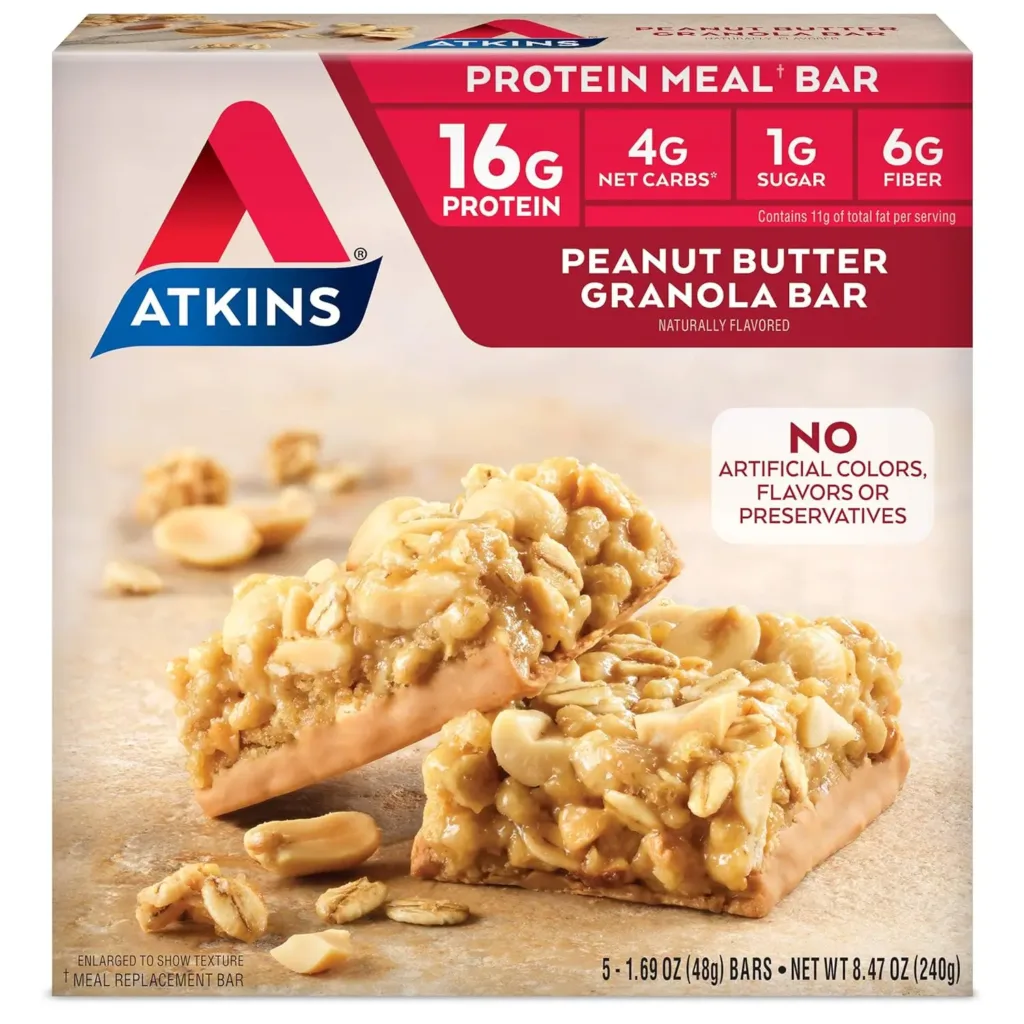Displayed is a box of Atkins Peanut Butter Granola Bars, emphasizing its high protein content with 16g of protein, low net carbs at 4g, and minimal sugar with 1g per serving. The image also shows two bars in the foreground to highlight their rich texture and wholesome ingredients.