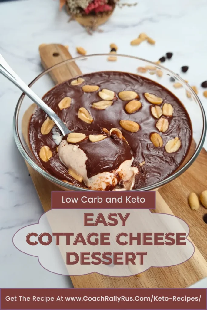 Delicious Cottage Cheese Peanut Butter Dessert served in a clear glass bowl, featuring a smooth chocolate layer and garnished with peanut halves, presented on a marble surface with a wooden board in the background. Perfect for a Pinterest pin showcasing an easy, low-carb, and keto-friendly treat.
