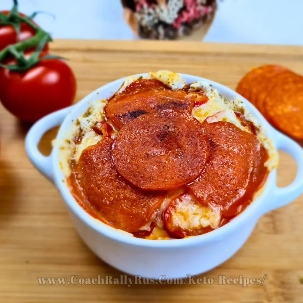 Keto-friendly Cottage Cheese Pizza Bowl topped with pepperoni slices, garnished with fresh herbs, and served in a white bowl on a rustic wooden table, ready to enjoy.