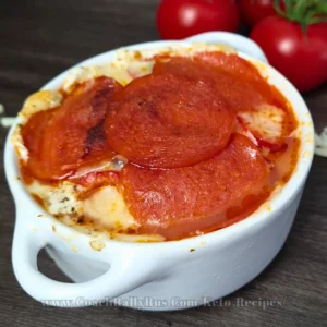 A savory Cottage Cheese Pizza Bowl topped with pepperoni slices, showcasing a delicious blend of melted cheese and herbs, perfect for a keto-friendly meal.