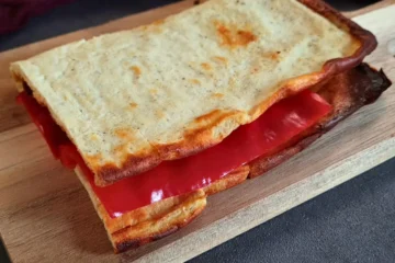 Golden-brown cottage cheese flatbread with a crispy edge, fresh out of the oven, displayed on a light countertop, embodying the simplicity and deliciousness of keto-friendly recipes.