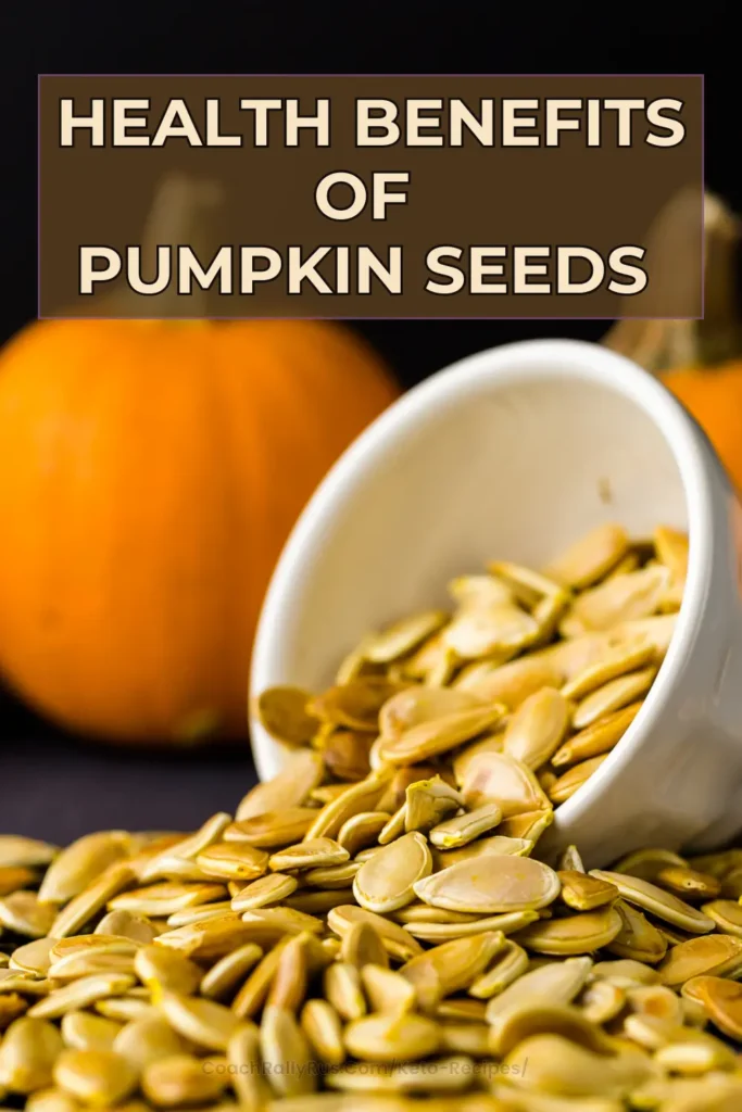 A Pinterest pin featuring the title ‘Health Benefits of Pumpkin Seeds’ in bold white letters at the top against a dark background. Below, a white ceramic cup is tipped over, spilling a bounty of pumpkin seeds onto a surface. In the background, an intact pumpkin sits to the left, suggesting the source of these seeds and emphasizing their natural origin.
