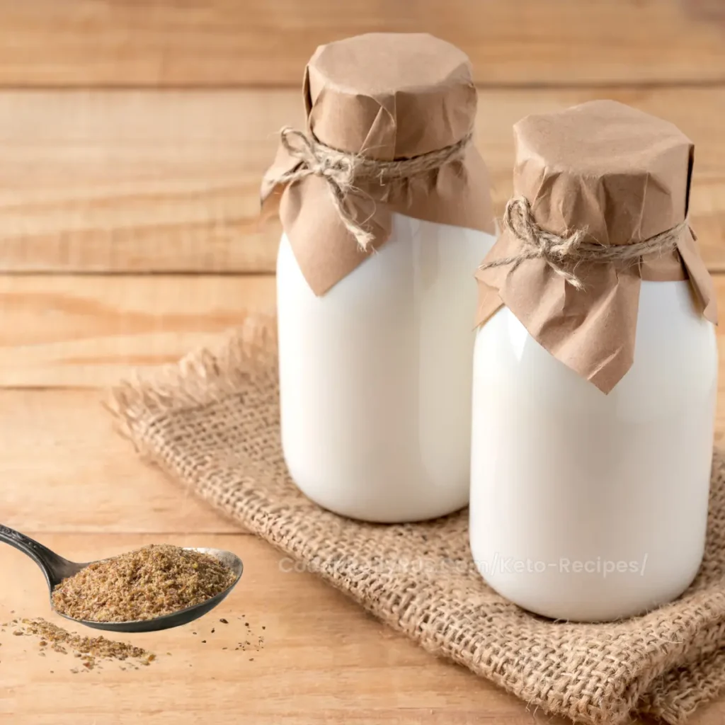 Glass jar of creamy kefir with a bowl of ground flaxseed flour.