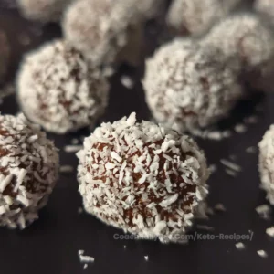 Close-up of keto chocolate rum balls coated in coconut.