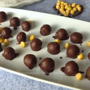 Plate of Keto Chocolate Hazelnut Cottage Cheese Bonbons with hazelnuts - low carb, sugar-free, high-protein keto treat