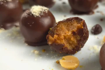 Keto Chocolate Peanut Butter Cottage Cheese Bonbon with a bite taken out, showing the creamy peanut butter filling.
