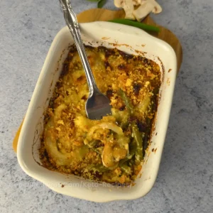 Overhead view of keto green bean casserole with a golden crispy onion topping.