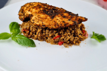 One Skillet Keto Mediterranean Chicken Dinner served over cauliflower and broccoli rice, garnished with basil and parsley.