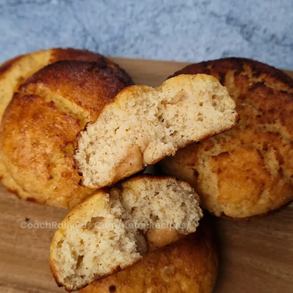 Keto brioche bun cut in half showing fluffy texture.