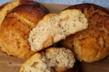 Keto brioche bun cut in half showing fluffy texture.