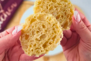 Hand holding fluffy slices of keto mug bread