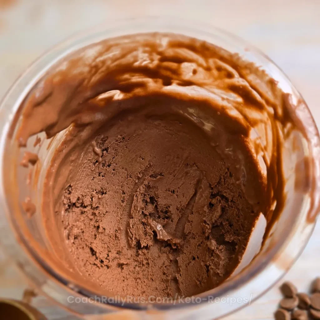 Smooth chocolate cottage cheese ice cream inside Ninja Creami pint