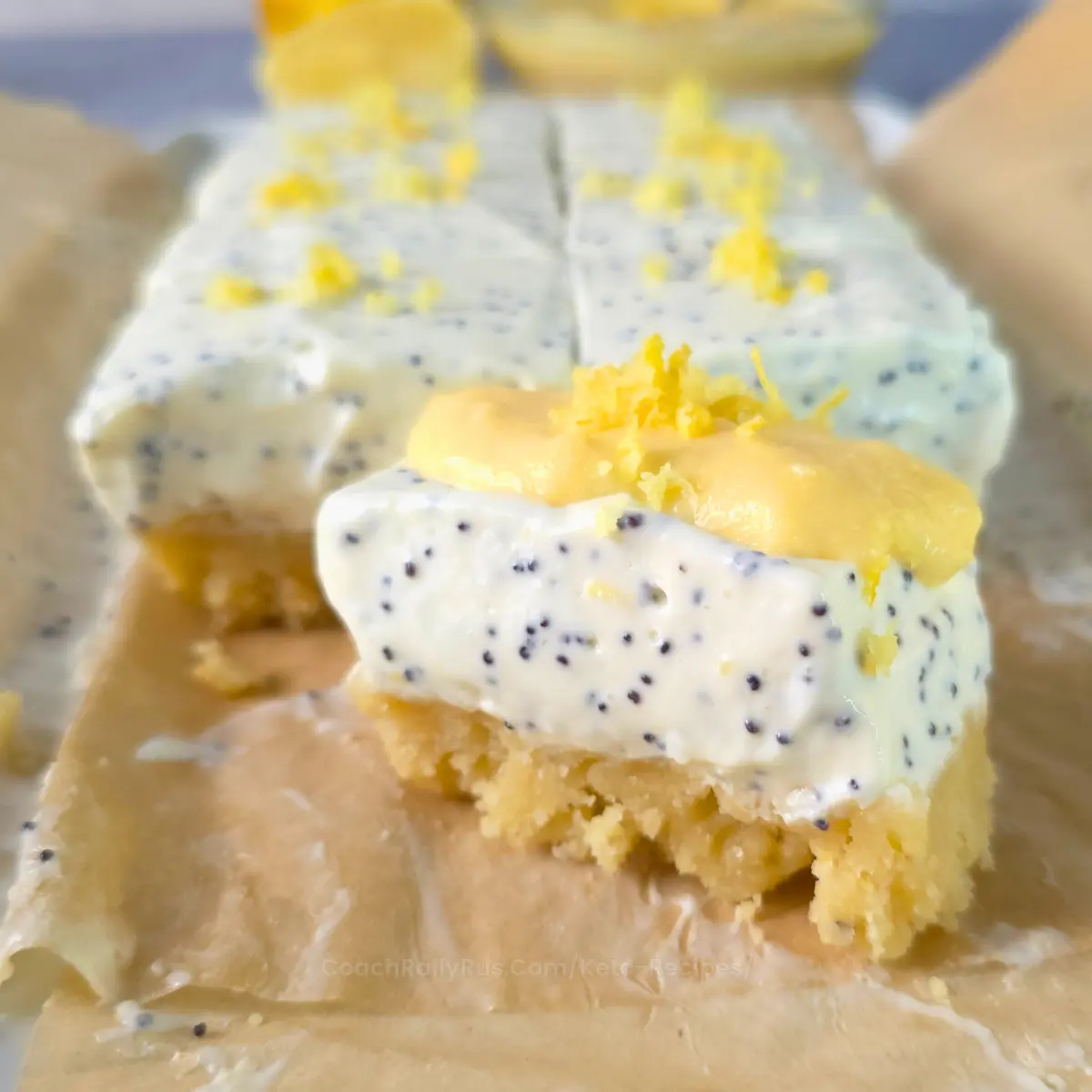 Close-up of a sliced keto lemon poppy seed cottage cheese bar topped with lemon zest.