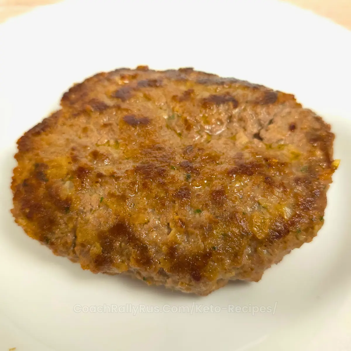 Cooked keto Mediterranean burger patty on a plate