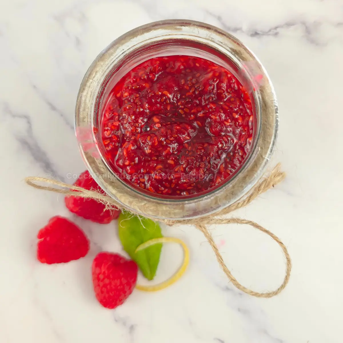 Top view of a jar filled with vibrant raspberry chia jam
