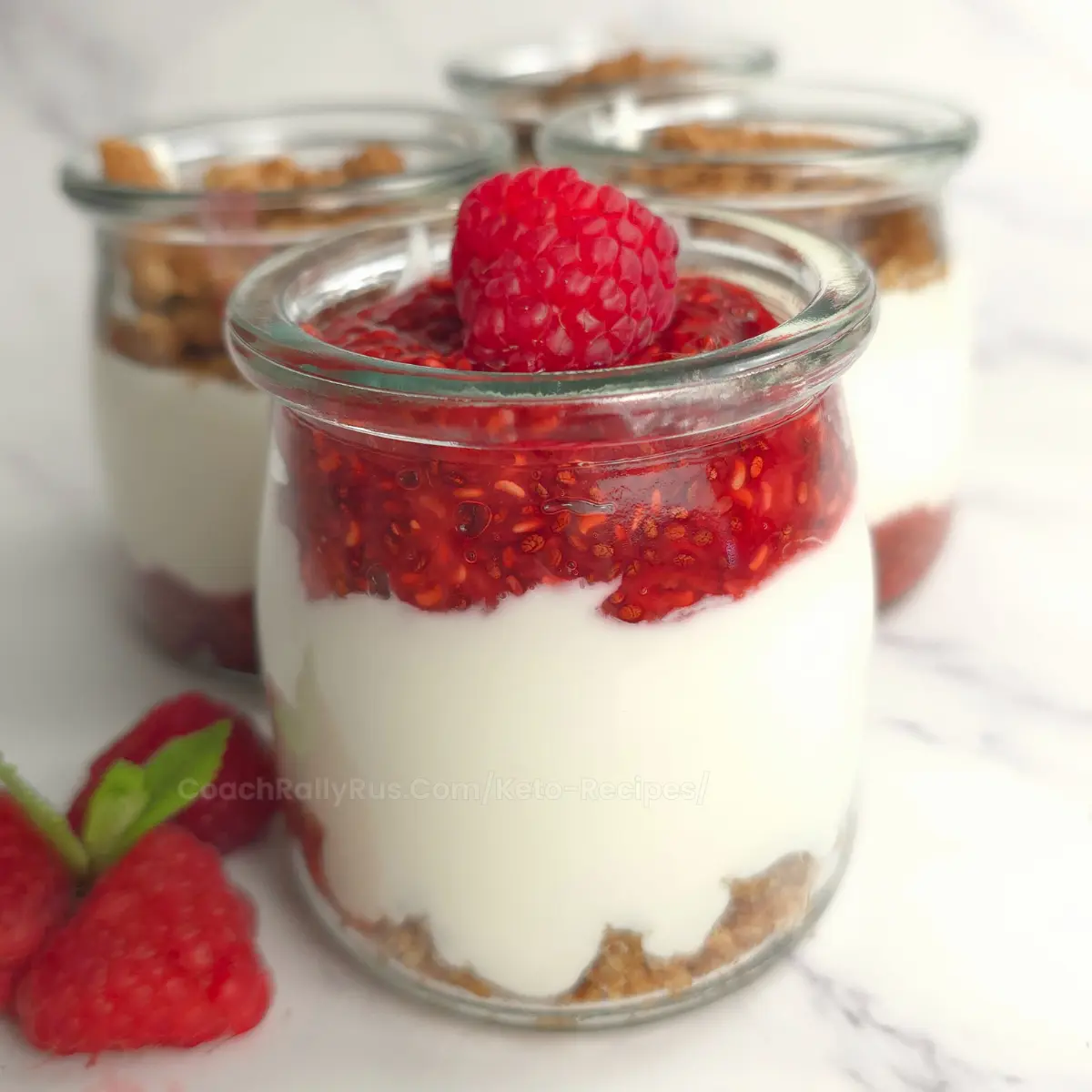 Close-up of raspberry chia jam parfait with cottage cheese in a jar