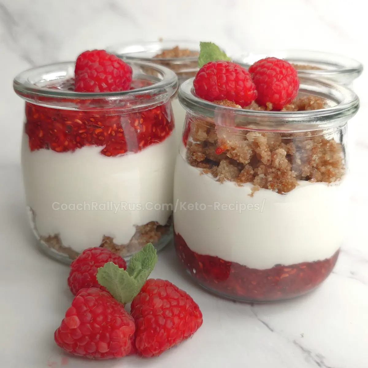 Three jars of keto raspberry parfait with cottage cheese and crumble