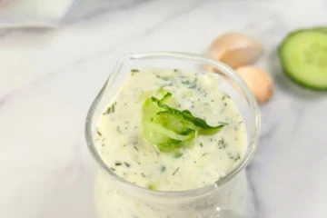 Closeup of cottage cheese tzatziki with cucumber garnish