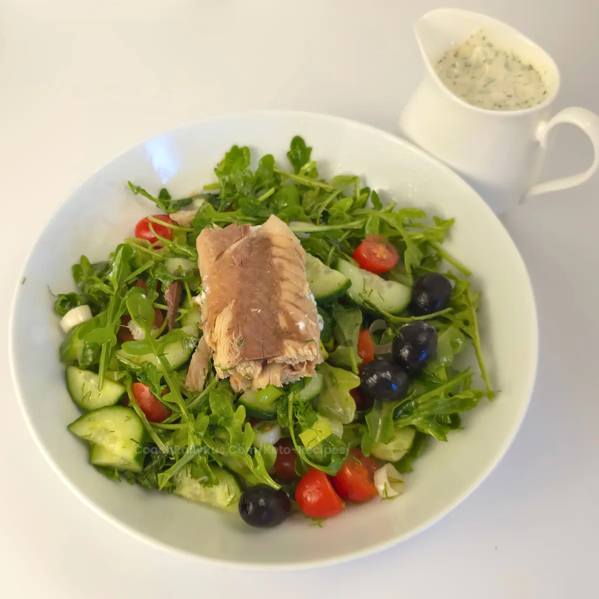 Mackerel salad ingredients arranged in a bowl with ranch sauce