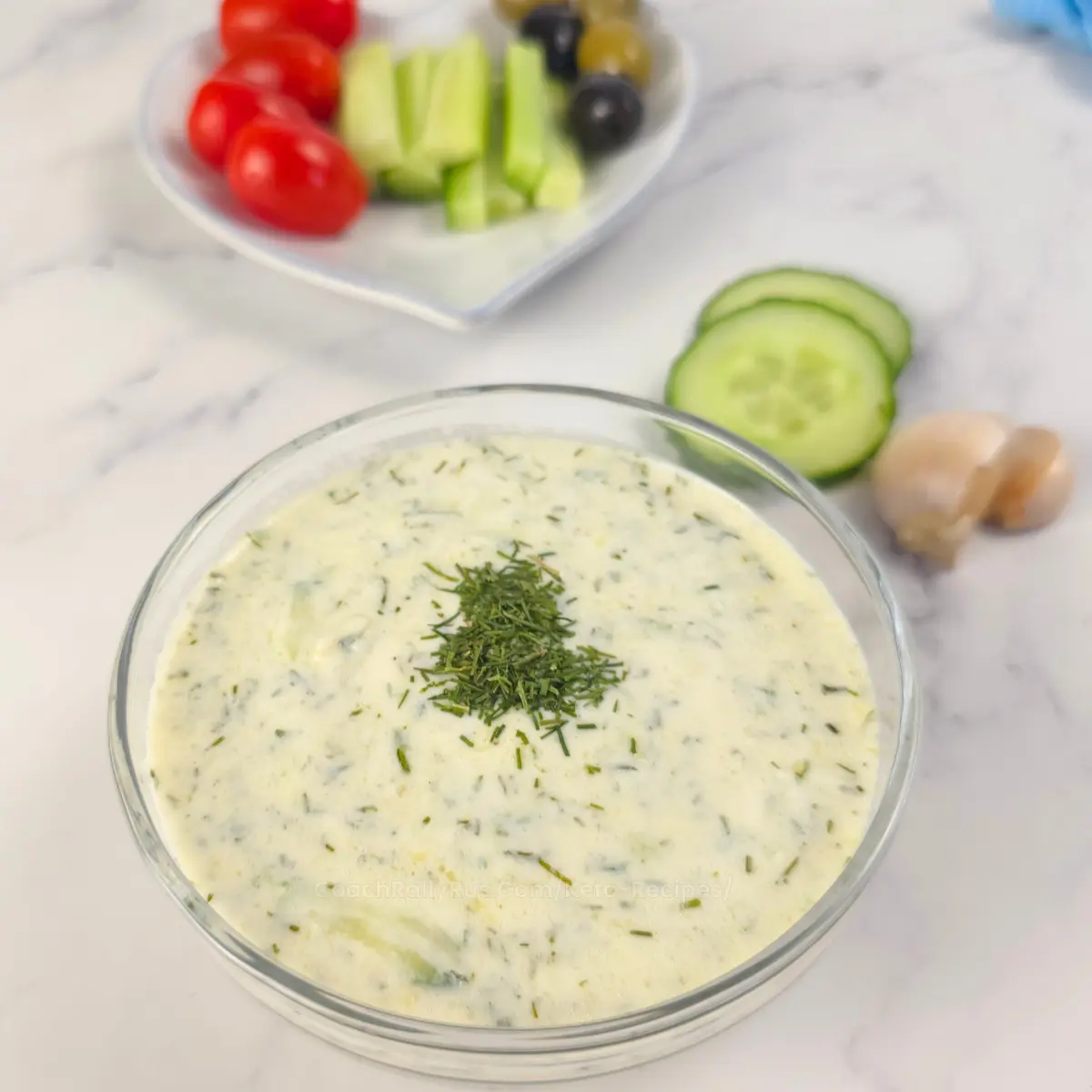 Close-up of creamy keto tzatziki sauce with dill garnish