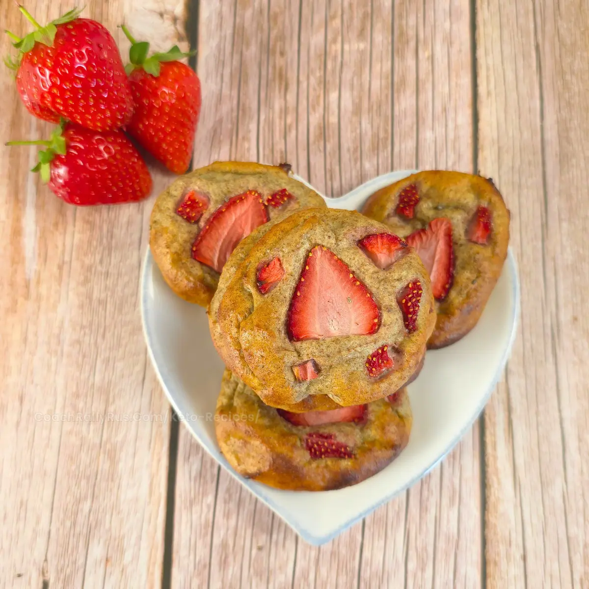Stack of strawberry chia seed cookies with a fresh strawberry