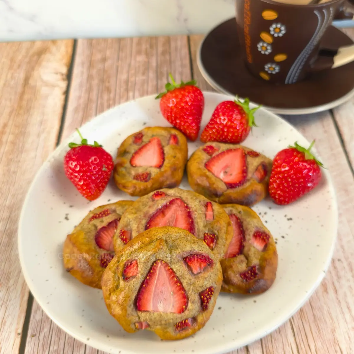 Overhead view of strawberry chia cookies with coffee and berries