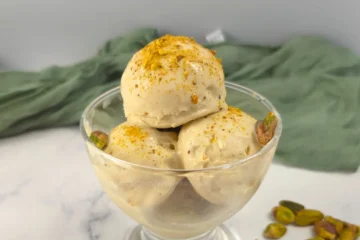 Creamy keto pistachio ice cream made with cottage cheese, served in a sundae glass.